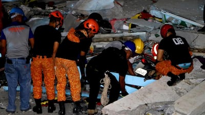 Emergency responders continue search operations at a damaged commercial building following an earthquake in Porac town, Pampanga Province, north of Manila. EPA