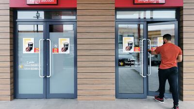 A Saudi man walks through the "Single Section" entrance at a McDonald's outlet in Khobar. Saudi authorities announced on December 8, 2019 that restaurants would no longer be required to segregate unrelated male and female customers. Reuters