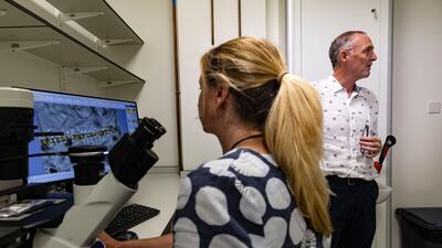 The team examines samples taken during a boat ride