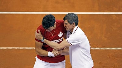 Canada's Milos Raonic, left, is consoled by Martin Laurendeau, Canada's team captain, after having lost his Davis Cup semi-finals match against Serbia's Novak Djokovic in Belgrade, Serbia. Djokovic's teammate, Janko Tipsarevic, would send Canada packing for home. Marko Drobnjakovic / AP Photo