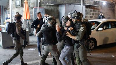 Israeli security forces detain a Palestinian protester outside the Damascus Gate in Jerusalem's Old City, amid tensions following yesterday's clashes between Palestinians and far-right Jews. AFP