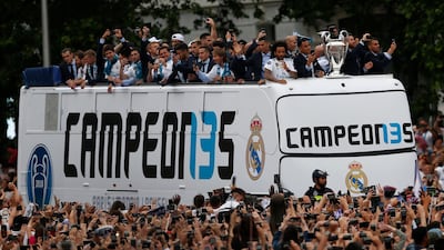 Real Madrid players wave to fans from the top of an open top bus in Cibeles square, in Madrid, Spain, Sunday, May 27, 2018. Francisco Seco / AP Photo