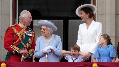 Prince Charles, left, with the queen, Prince Louis her grandson, covering his ears with his hands, next to Kate and Princess Charlotte, on the balcony of Buckingham Palace. AP
