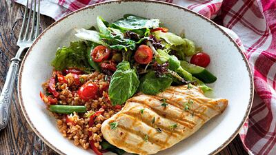 Chicken breast with bulgur tabbouleh and green salad. Getty