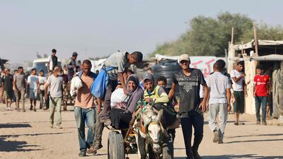 Palestinians make their way along Al Rashid Street in western Jabalia after receiving humanitarian aid from a distribution point in northern Gaza. AFP