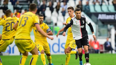 Juventus' Cristiano Ronaldo in action with Hellas Verona's Marash Kumbulla and Miguel Veloso. Reuters