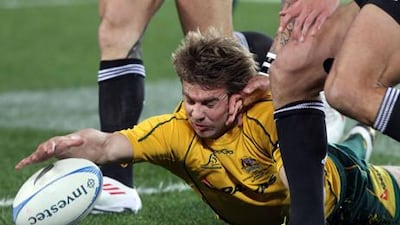 Australia's Drew Mitchell dives for the ball against New Zealand in the Rugby Championship clash in Auckland