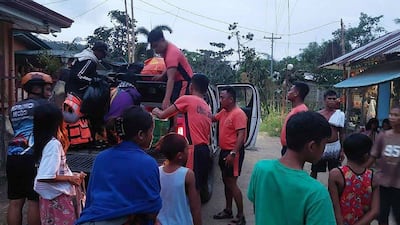 Coast guard personnel assist residents in Mobo, Masbate province. AFP