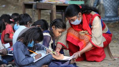 Underprivileged children attend an outdoors class at the Sangharsh Vidya Kendra school, at a slum area on the outskirts of Jammu, India. EPA