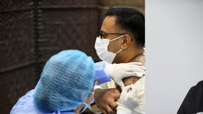 A man receives the Covid-19 vaccine at the Ajman Society of Social & Cultural Development centre.