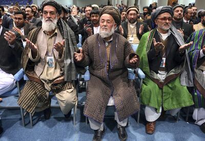 Members of the Afghan loya jirga, a meeting of around 2,500 Afghan tribal elders and leaders, pray on the last day of the four-day long loya jirga in Kabul on November 24, 2013. AFP