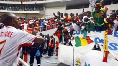Mali player El Hadj Mahamane Traore throws a shirt towards fans after the opening match against Angola.