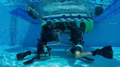 Peter Podlunsek of Slovenia seen during the underwater rescue training before the first stage of the Red Bull Air Race World Championship in Abu Dhabi. Predrag Vuckovic / Red Bull