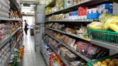 While global economic strife kept shoppers away from high-end stores, they continued to spend on staples at the supermarket.