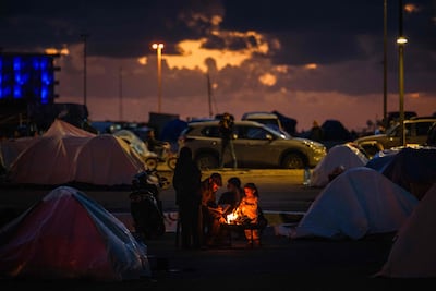 Displaced people gather around a fire on Beirut's seafront. AFP