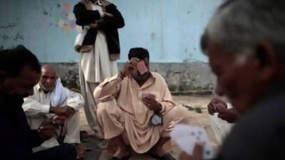 Pakistani men play cards in an alley in Islamabad. For months, the Supreme Court's chief justice Iftikhar Chaudhry has been leading special hearings on Karachi's crime, berating the city's top police officers for failing to act.