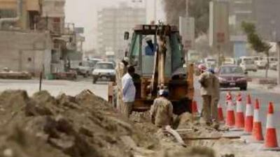 Labourers work on a road project in Ras al Khaimah.
