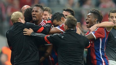 Bayern Munich's team members celebrate after Jerome Boateng, centre, scored during the first leg Uefa Champions League Group E football match against Manchester City in Munich. Christof Stache / AFP