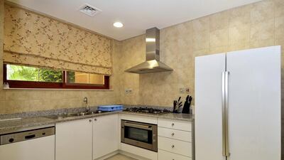 One of the kitchens inside the Dh20 million five-bedroom villa in Jumeirah Islands’ Mansions in Dubai. Courtesy Better Homes