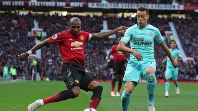 Manchester United's Ashley Young, left attempts to cross the ball as Newcastle United's Javier Manquillo challenges. AP Photo
