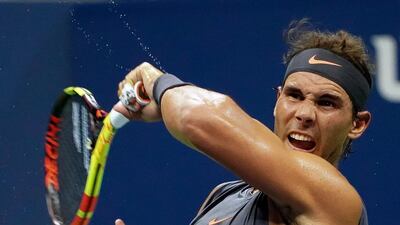 Rafael Nadal returns a serve from fellow Spaniard David Ferrer on his way to a first-round victory at the US Open. EPA