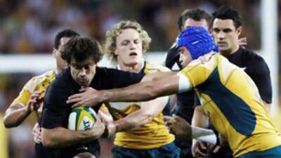 New Zealand's Conrad Smith palms off Australia's Nathan Sharpe during the Bledisloe Cup match in Brisbane.