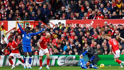 Nottingham Forest's Jonjo Shelvey brings down Everton's Dwight McNeil to give away a penalty. Reuters