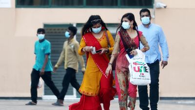 People wearing a protective face mask as a preventive measure against the spread of coronavirus in the Bur Dubai area in Dubai.