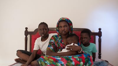 Abukk Sebit, 25 years old, poses with her children after working to help her family in Sudan financially at Ain Shams district area in Cairo, Egypt September 13, 2022. Reuters