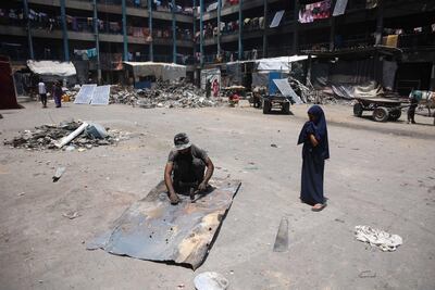 Palestinians in the grounds of a partially destroyed school being used as a shelter by internally displaced families in the Jabalia refugee camp. AFP