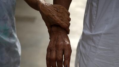 An elderly Indian couple leaves after casting their votes at a polling station during the fourth phase of general election in Mumbai on April 29, 2019. AFP