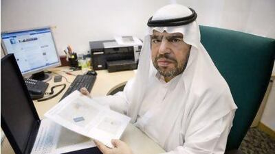 Abdulla Mohammed Tayyeb Khoory, the president of the Emirates Philatelic Association, shows a stamp from 1929.