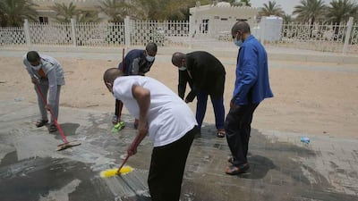 These five men were fined and made to sweep the streets for reckless driving.