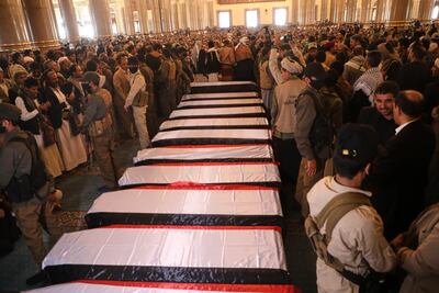 People gather beside the coffins of Houthi officials at Al Shaab Mosque in Sanaa. AP