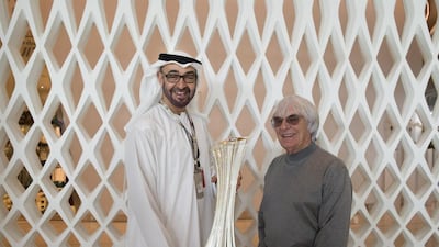 General Sheikh Mohamed bin Zayed Crown Prince of Abu Dhabi Deputy Supreme Commander of the UAE Armed Forces (L), holds the Yas Marina Circuit Formula One Perpetual Trophy. Seen with: Bernie Ecclestone (R), President & CEO of Formula One Management on the final day of the Etihad Airways F1 Abu Dhabi Grand Prix at Yas Marina Circuit. Ryan Carter / Crown Prince Court - Abu Dhabi