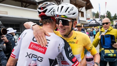 Felix Grossschartner, left, of UAE Team Emirates greets Tadej Pogacar after the fifth and last stage of Tour de Romandie. EPA