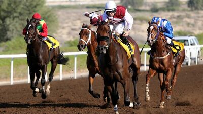 Farrier and jockey Richard Mullen, second right, pull away during the 1,950m conditions race at Jebel Ali Racecourse on Friday. Mohamed Hanifa / Al Ittihad