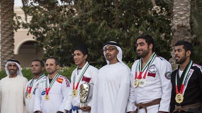 Sheikh Mohammed bin Zayed , Crown Prince of Abu Dhabi and Deputy Supreme Commander of the Armed Forces, and Sheikh Nahyan bin Zayed, Chairman of the Board of Trustees of Zayed bin Sultan Al Nahyan Charitable and Humanitarian Foundation, stand for a photograph with winners of the Abu Dhabi World Professional Jiu-Jitsu Championship 2016, seen during a Sea Palace barza. Ryan Carter / Crown Prince Court - Abu Dhabi