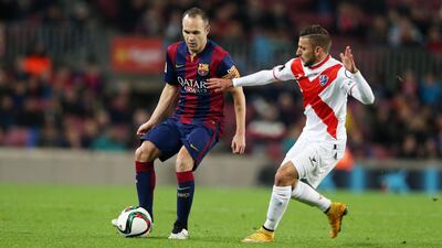 A group of supporters for Barcelona, for whom Andres Iniesta, left, is seen in action, inspired the creation of SD Huesca, in white and red. Miguel Ruiz / Getty Images