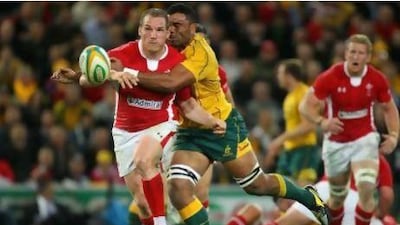 Gethin Jenkins of Wales is tackled by Wycliff Palu of the Wallabies.