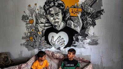 Children beneath a mural in the central Gaza Strip. AFP