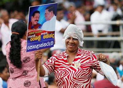A Rajapaksa supporter reacts during a rally. Reuters