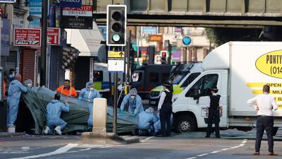 FILE - In this file photo dated Monday, June 19, 2017, forensic officers move the van which struck pedestrians near a Mosque at Finsbury Park in north London. A Crown Court on Thursday Feb. 1, 2018, found Darren Osborne guilty of murder and attempted murder in the June 2017 attack in the city's Finsbury Park neighborhood. (AP Photo/Frank Augstein, FILE)