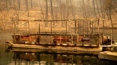A boat scorched by the Carr Fire floats on Whiskeytown Lake in Whiskeytown, California. AP Photo / Noah Berger