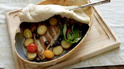 ABU DHABI - UNITED ARAB EMIRATES - 09OCT2013 - Fillet of baked red snapper with pizza dough crust, young potatoes and taggiasca olives at Villa Toscana Restaurant at St Regis Abu Dhabi in Abu Dhabi. Ravindranath K / The National (to go with Freelancer article for National) *** Local Caption *** RK0910-VILLATOSCANA01.jpg