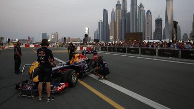 The Infiniti Red Bull Racing RB7 is pushed back into the garage during an Infiniti Red Bull Racing show run in Dubai.