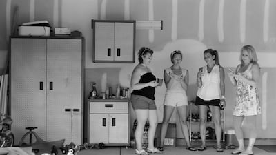 Three women stand next to each other, staring into the empty space between their hands. Courtesy Eric Pickersgill