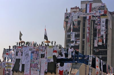Iraqi protesters gather atop the abandoned Turkish restaurant building at Baghdad's Tahrir Square. AFP