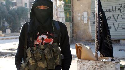 A member of jihadist group Al-Nusra Front stands in a street of the northern Syrian city of Aleppo on January 11, 2014. Fighting pitting the Islamic State of Iraq and the Levant (ISIL) against other rebel groups — including Al-Nusra Front, which is also linked to Al-Qaeda but is seen as more moderate — broke out in Syria last week. Baraa Al-Halabi / AFP photo