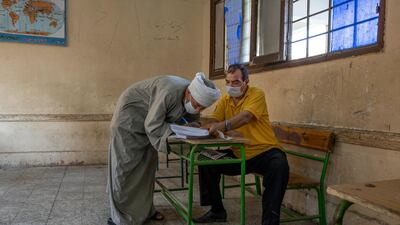 An election worker helps a man register his name to vote. AP Photo